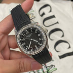 Patek Philippe luxury wristwatch with black dial, black rubber strap, silver diamond bezel