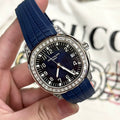 Luxury wristwatch with blue rubber strap, black dial, and diamond-studded bezel