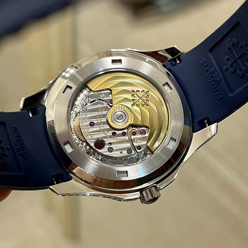 Mechanical watch caseback with exposed movement and blue rubber strap