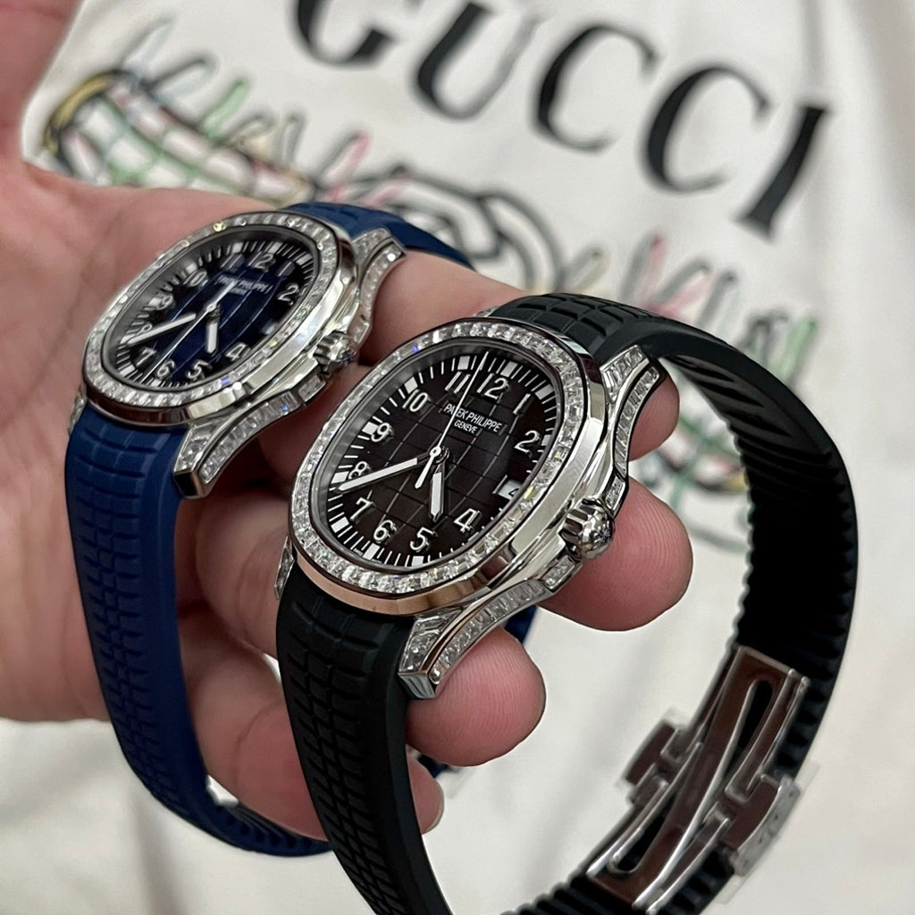 Two luxury wristwatches with diamond bezels, blue and black rubber straps