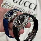 Two luxury wristwatches with diamond bezels, blue and black rubber straps