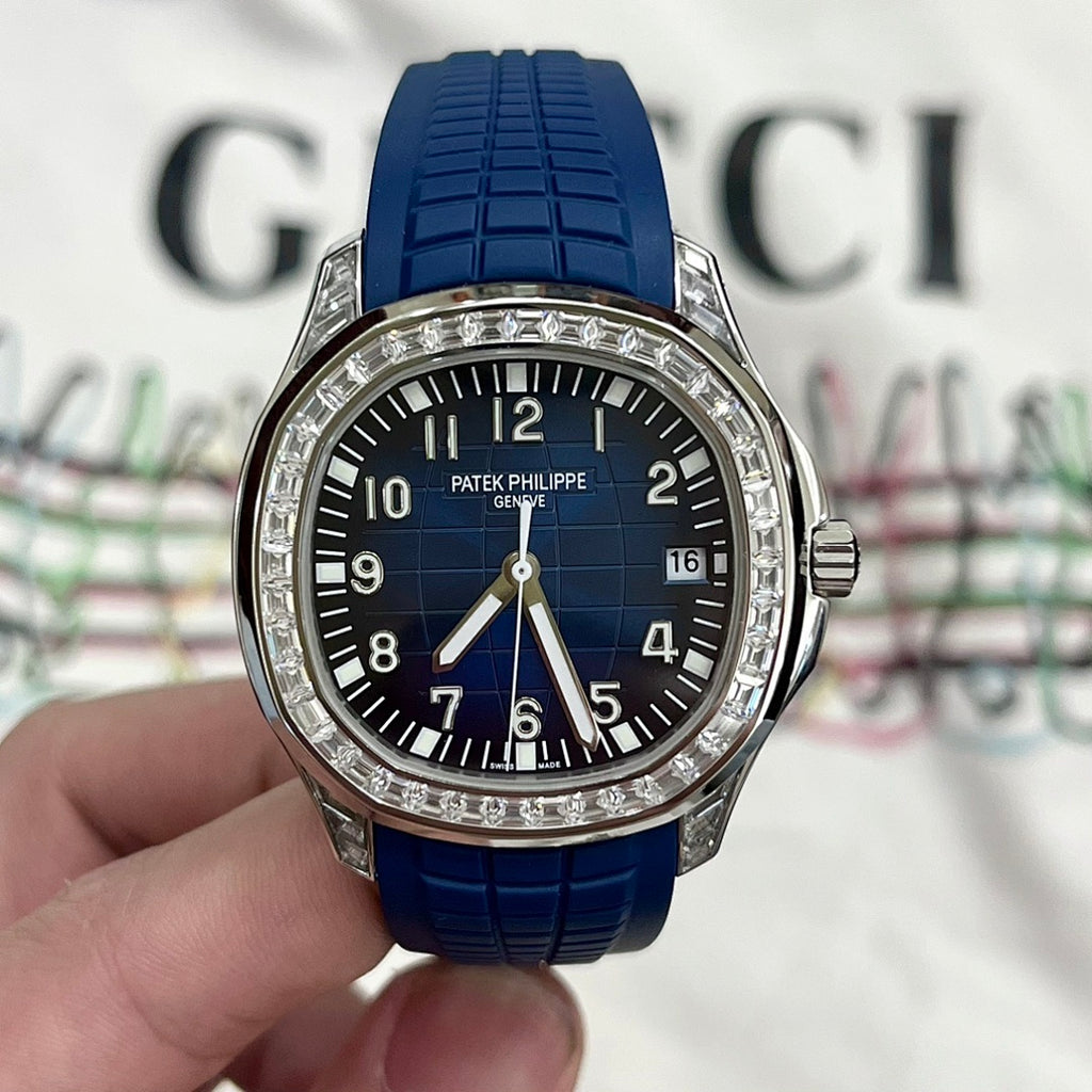 Luxury wristwatch with blue rubber strap, dark blue dial, and diamond bezel