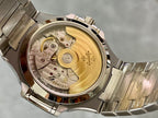 Patek Philippe open caseback view with gold-toned movement and steel back