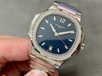 Patek Philippe wristwatch with blue dial and diamond bezel on metal bracelet