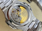 Patek Philippe steel watch case back showing mechanical movement through glass