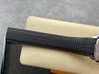 Patek Philippe watch strap section in black rubber with textured grid pattern.