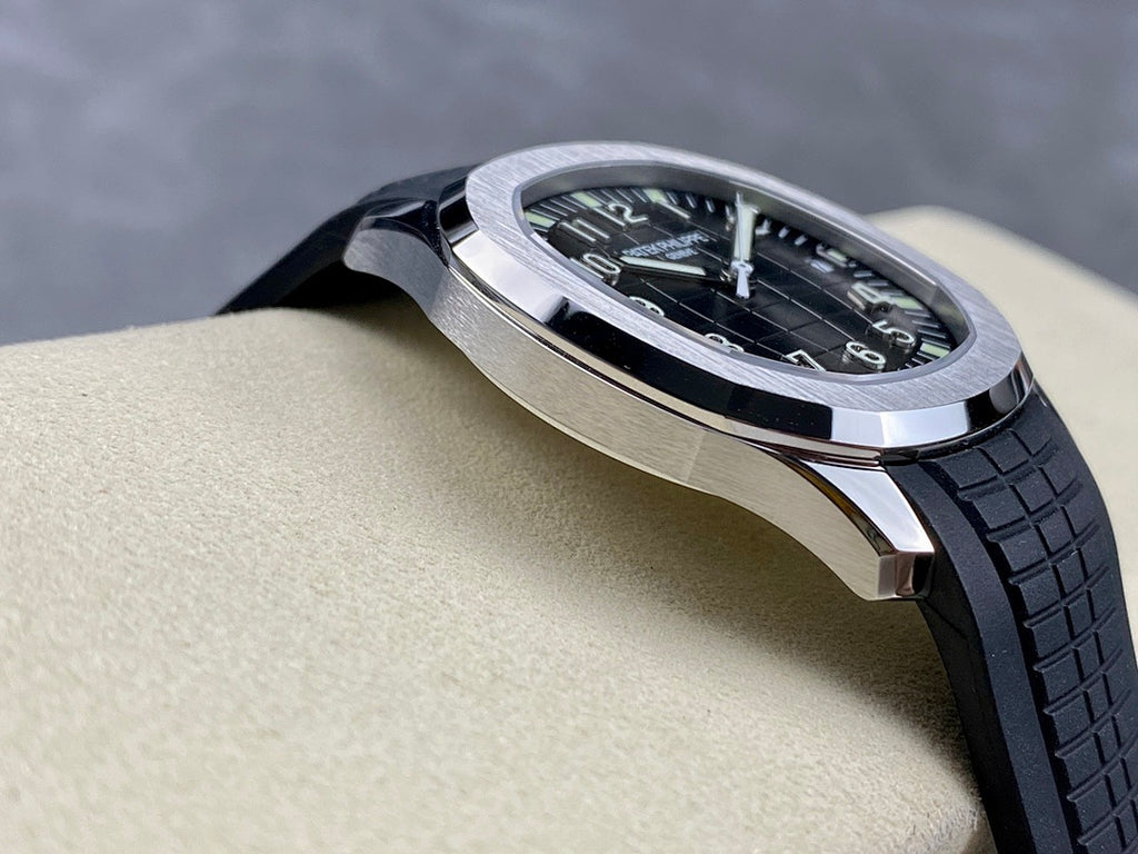 Patek Philippe wristwatch side profile with black rubber strap and silver case.