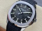 Patek Philippe wristwatch with black dial, silver case bezel, black rubber strap.
