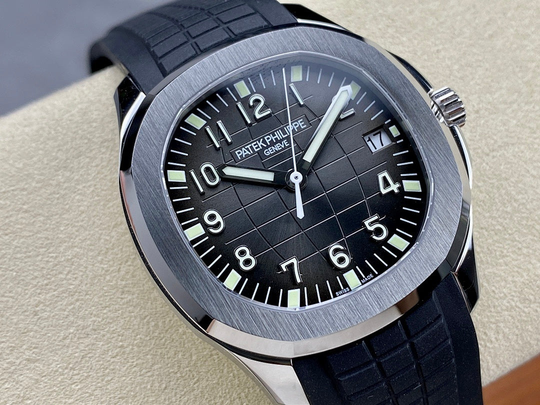 Patek Philippe wristwatch close-up: black dial, silver bezel, black rubber strap.