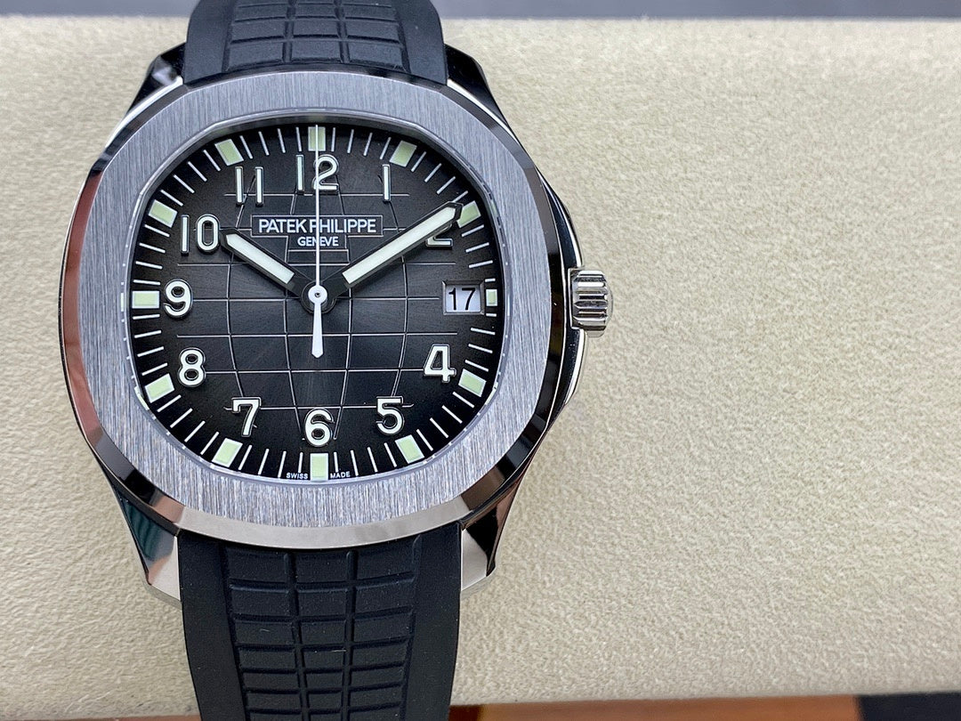 Patek Philippe wristwatch front view: black dial, silver bezel, black rubber strap.