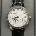 Patek Philippe watch with white dial, black leather strap, textured jeweled bezel