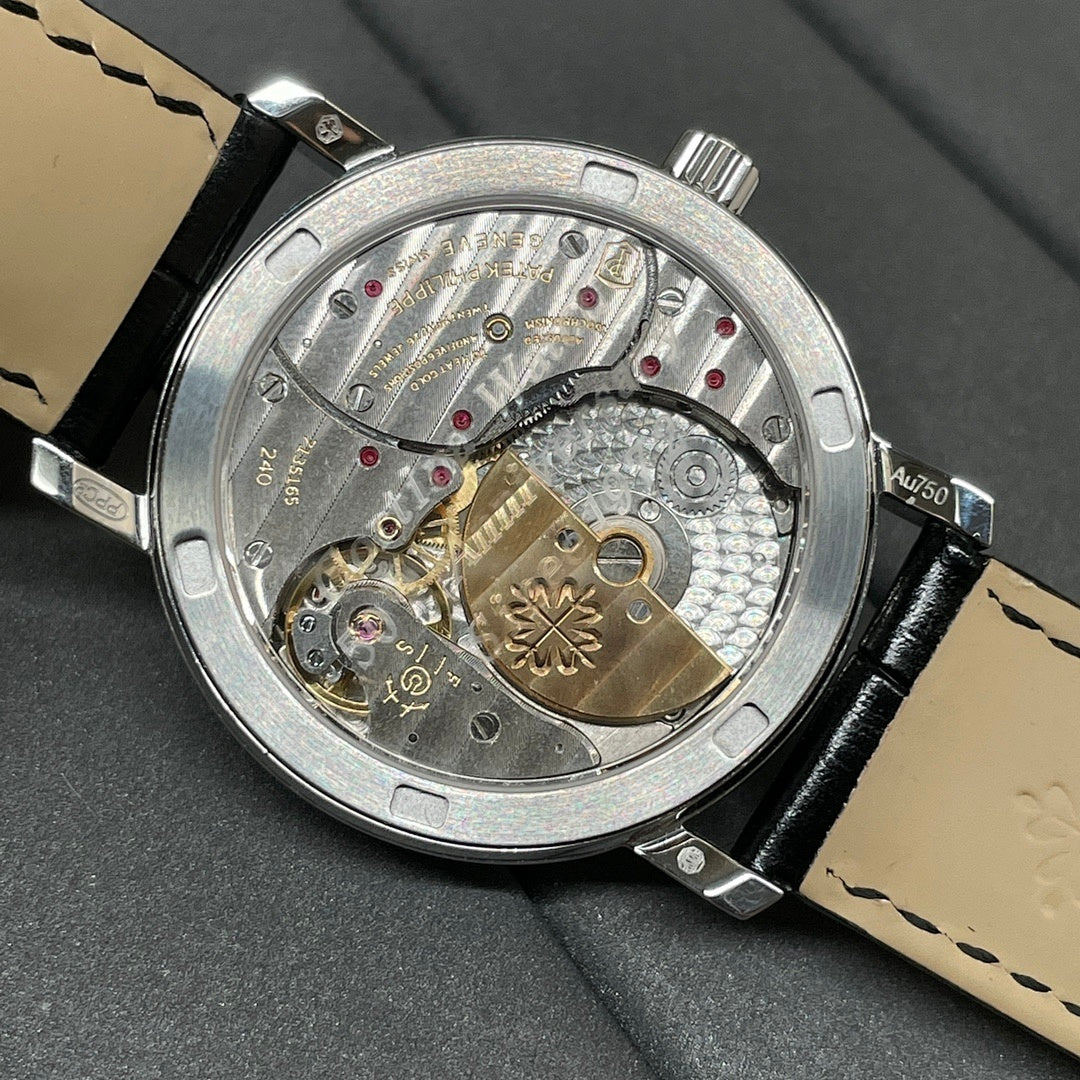 Patek Philippe watch back with visible movement and black leather strap