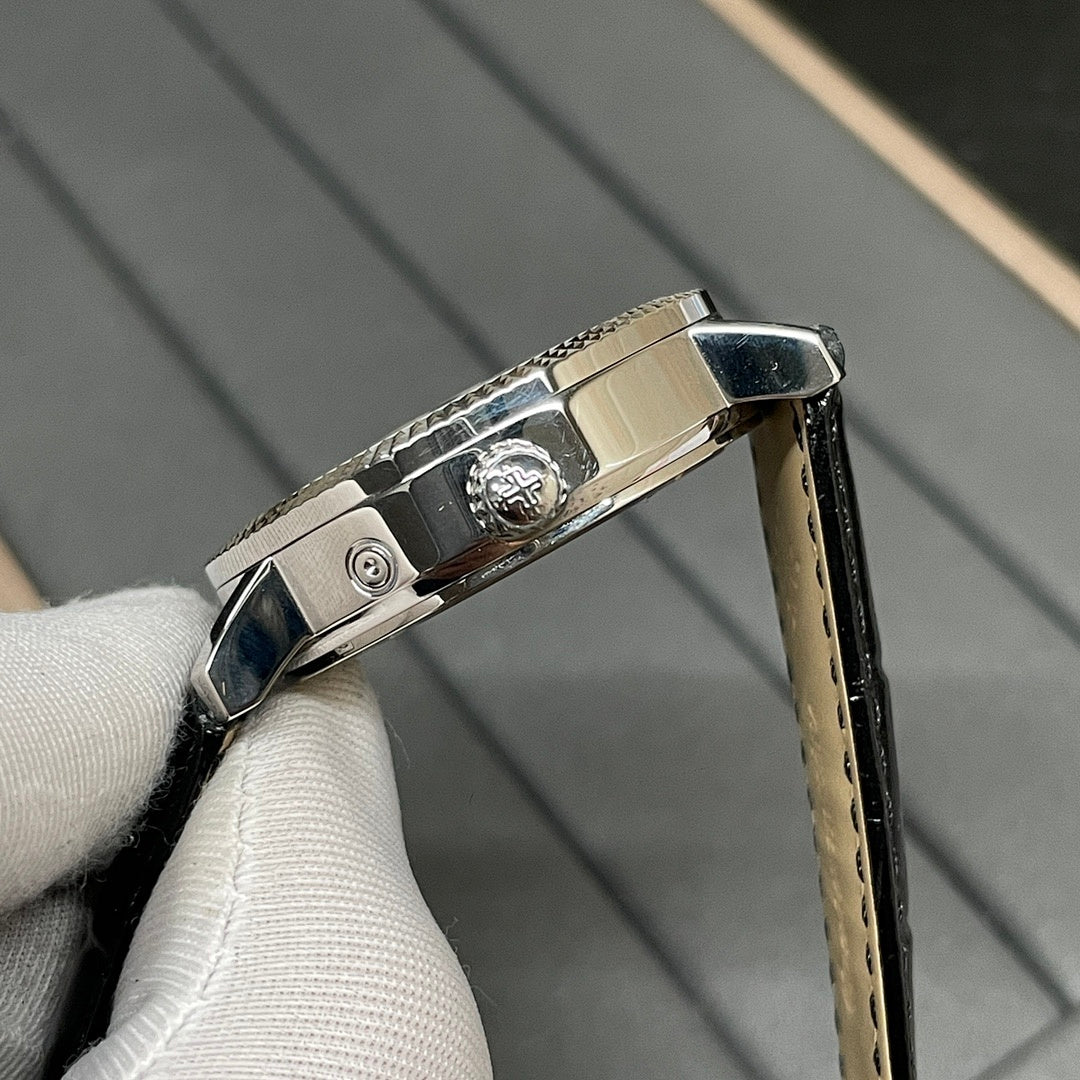 Patek Philippe watch side detail with crown and black leather strap