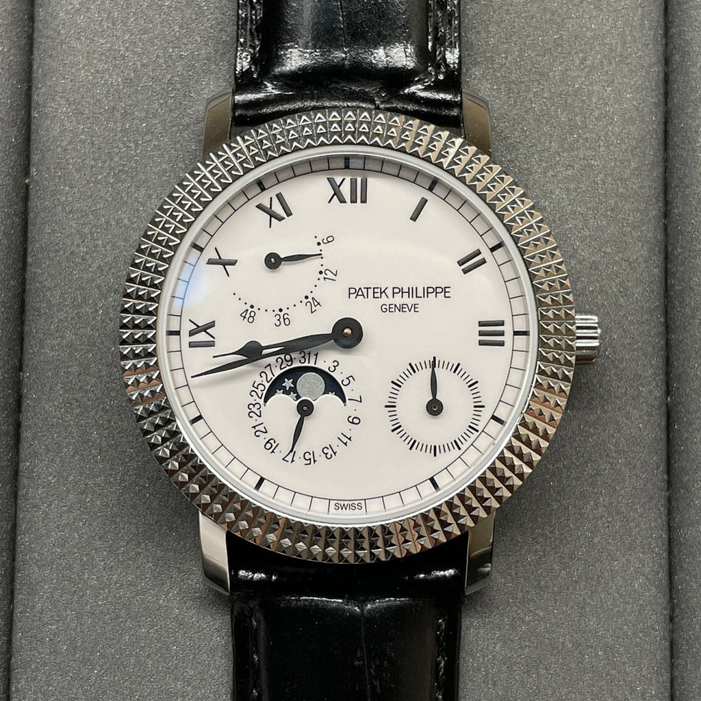 Patek Philippe watch face closeup with white dial, black leather strap, jeweled bezel