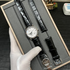 Patek Philippe watch with white dial and black leather strap