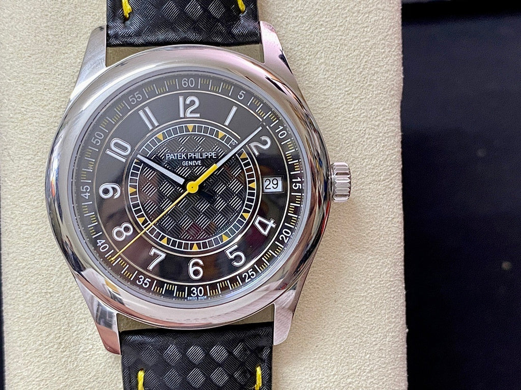 Luxury wristwatch with stainless case, dark dial, date window at 29, and black strap with yellow stitching.