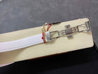 White rubber watch strap with metal clasp and buckle, side view