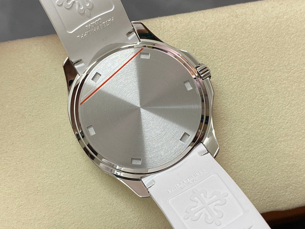 Silver watch case back with engraved details and white rubber strap, angled view