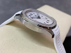Diamond bezel watch on wrist strap with white textured band, angled side view