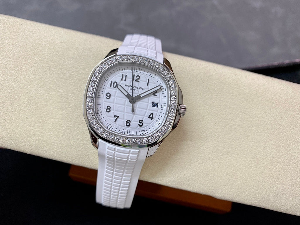 Diamond bezel watch with white dial and white textured rubber strap, on display