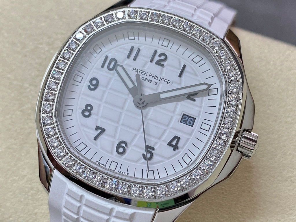 Diamond bezel watch with white dial and white textured rubber strap, close-up view