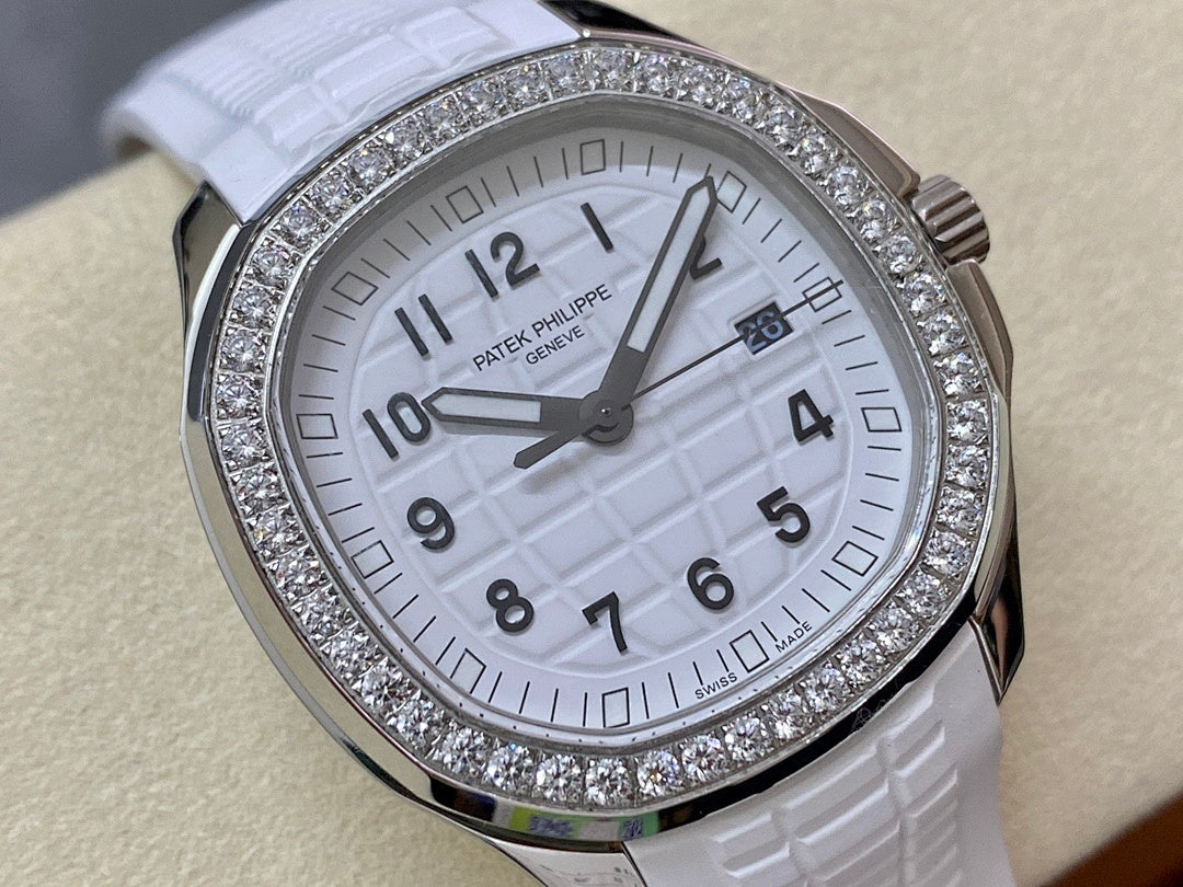 Diamond bezel watch with white dial and date window, close-up front view