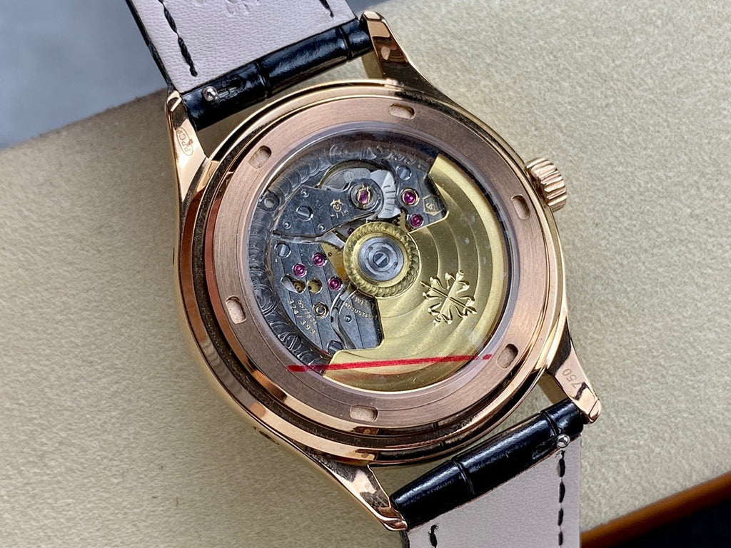 Patek Philippe watch with open caseback showing mechanical movement under glass