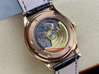 Patek Philippe watch with open caseback showing mechanical movement under glass
