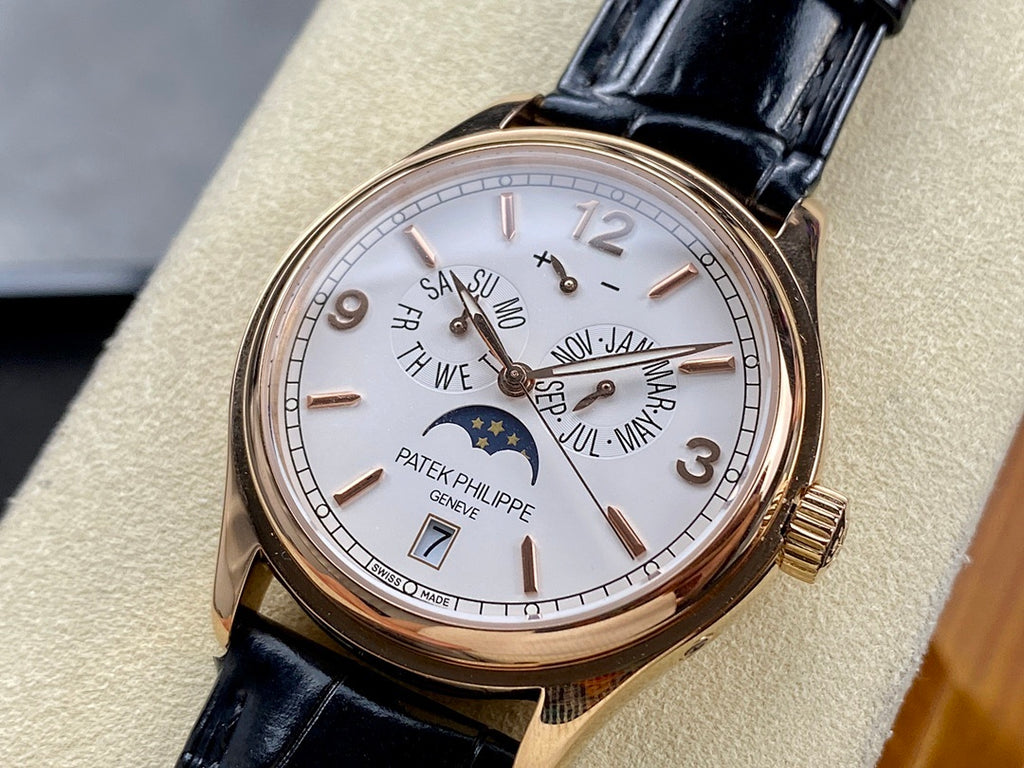 Patek Philippe watch with gold-tone case, white dial, black leather strap