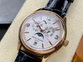 Patek Philippe watch with gold-tone case, white dial, black leather strap