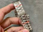 Stainless steel watch bracelet with fold-over clasp held in hand