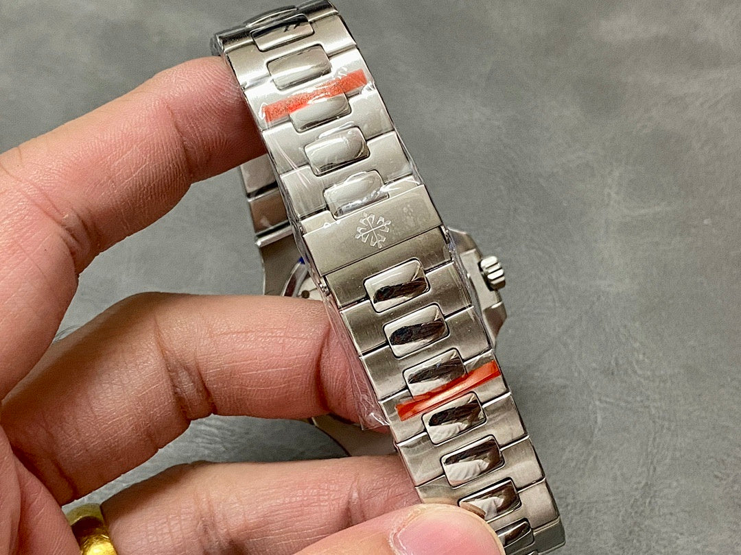 Stainless steel watch bracelet with fold-over clasp held in hand