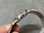 Stainless steel wristwatch on wristband view with blue gem on bezel
