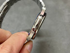 Stainless steel watch with crown side detail and rectangular case profile