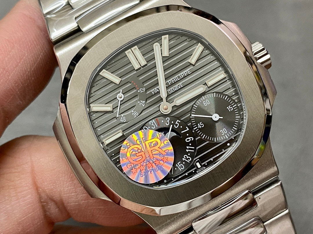 Close-up of stainless steel wristwatch dial with gray stripes and visible subdials