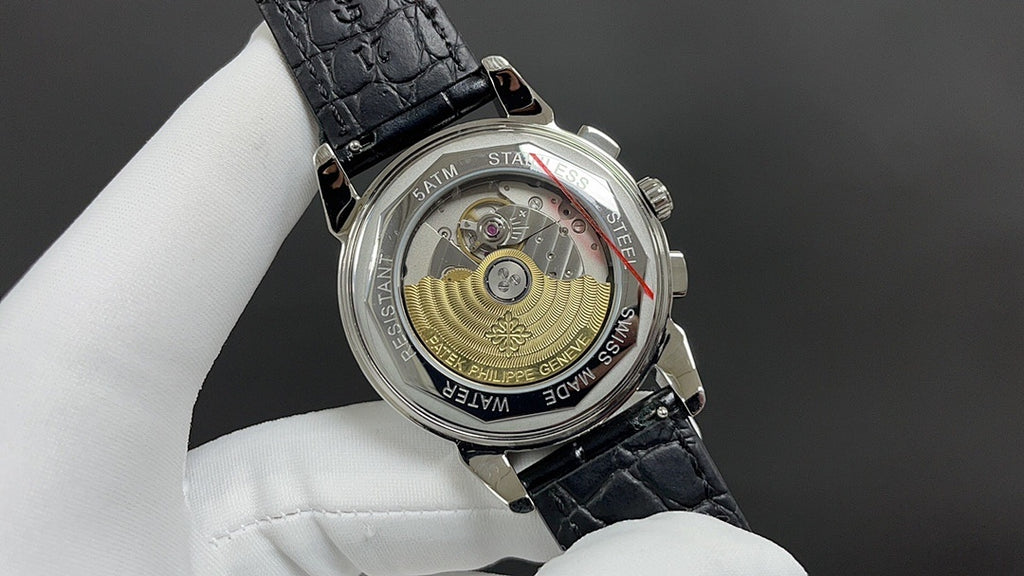 Patek Philippe watch caseback with see-through movement and black leather strap