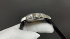 Patek Philippe watch crown side with stainless bezel and black leather strap