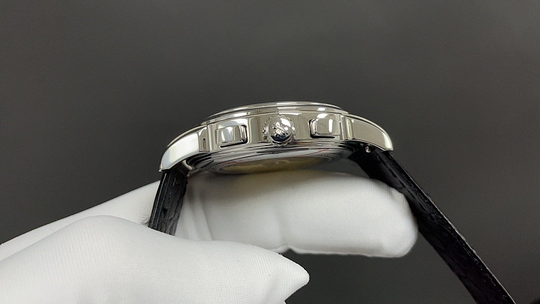Patek Philippe watch crown side with stainless bezel and black leather strap