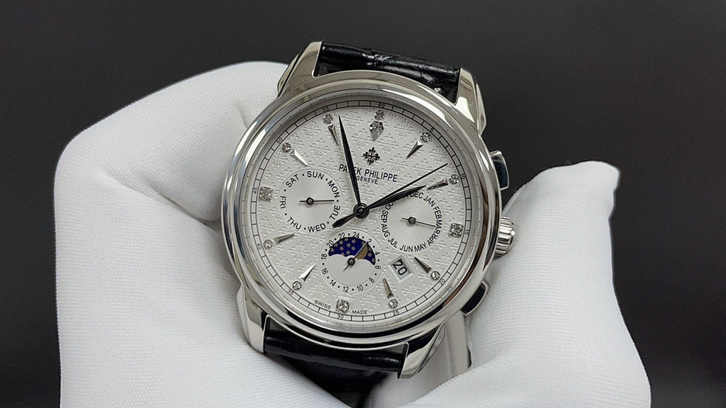 Patek Philippe watch with white dial and black leather strap