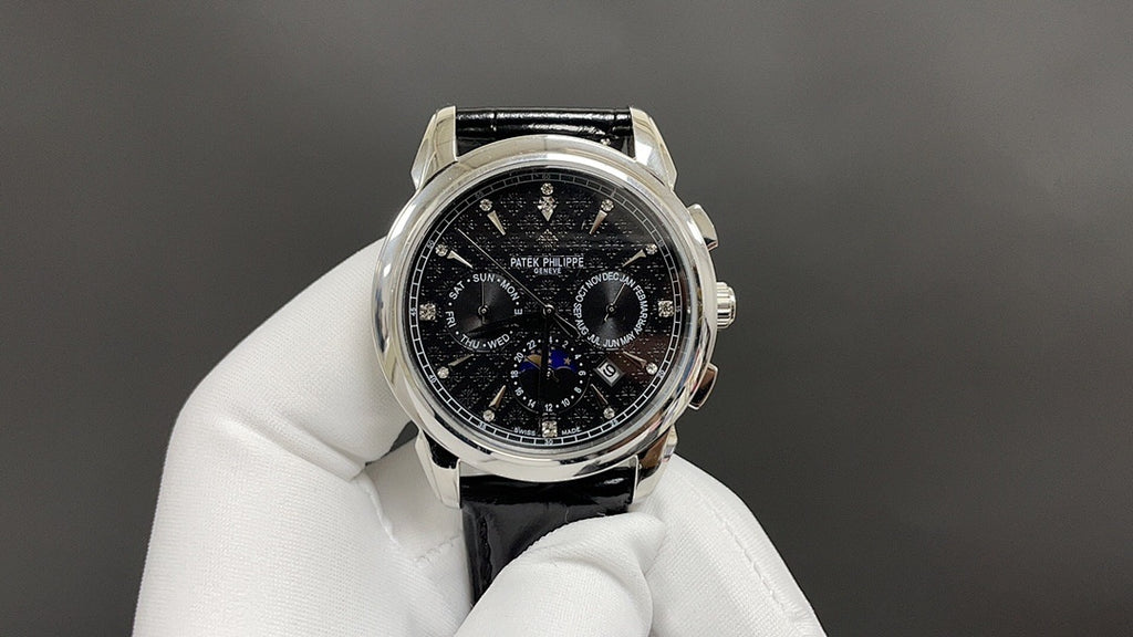 Patek Philippe chronograph watch with black dial, steel case, and black leather strap