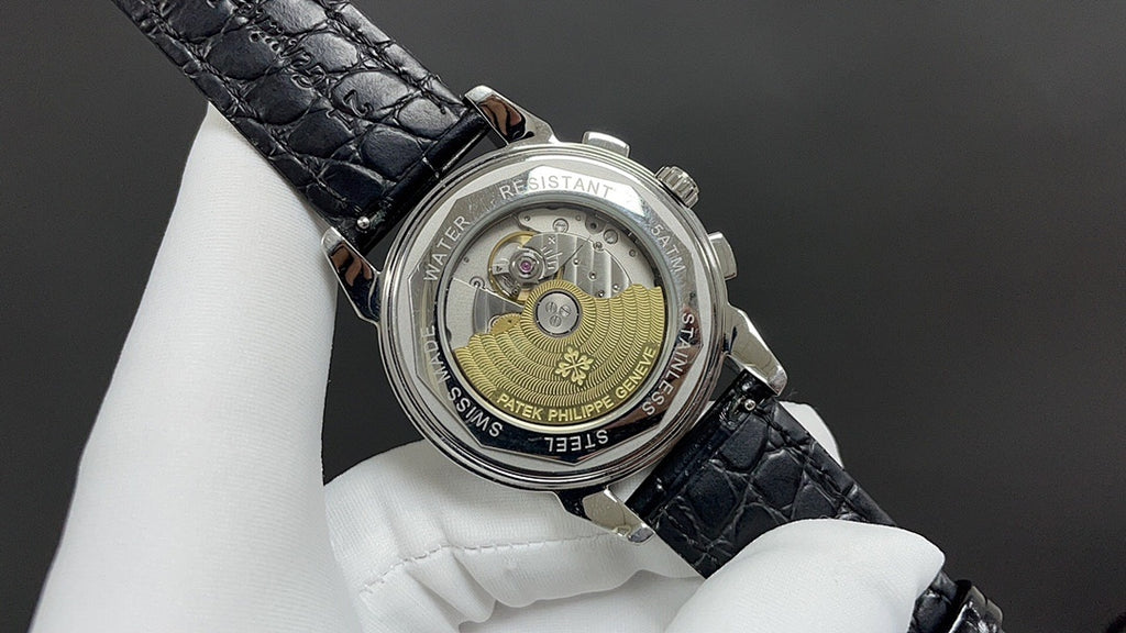 Patek Philippe watch caseback with visible movement and black leather strap