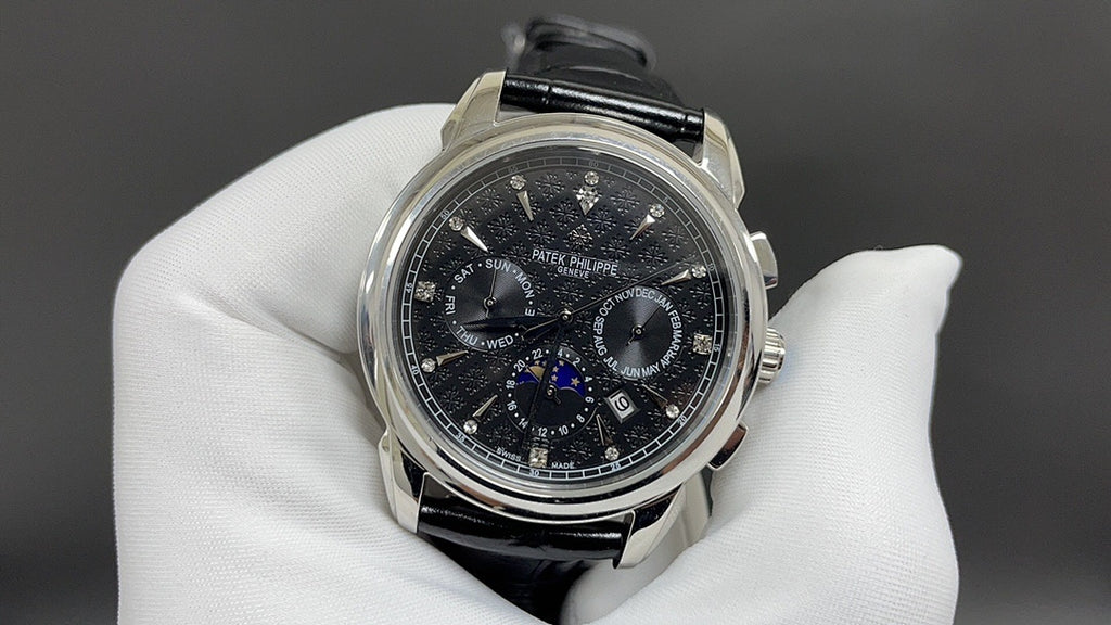 Patek Philippe chronograph watch with black dial and black leather strap, steel case