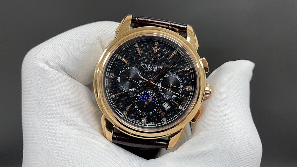 Patek Philippe wristwatch front view, dark dial with subdials, brown leather strap