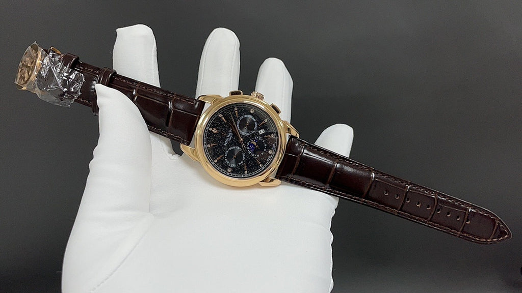 Patek Philippe wristwatch angled view, dark dial, brown leather strap, gold case