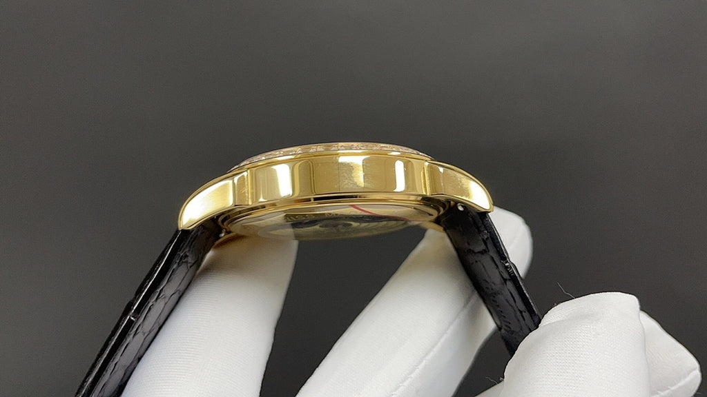 Patek Philippe wristwatch gold bezel side profile with black leather strap
