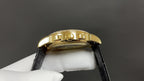 Patek Philippe wristwatch gold case side with black leather strap