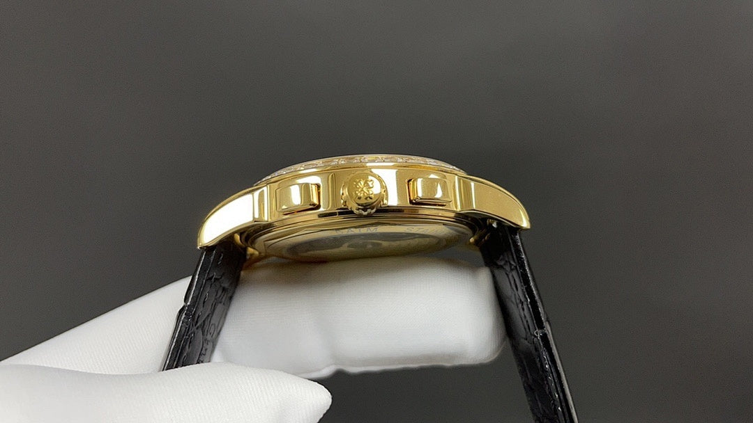Patek Philippe wristwatch gold case side with black leather strap