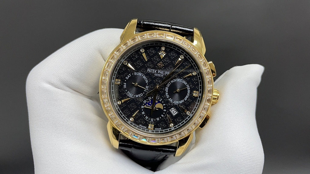 Patek Philippe wristwatch front view with black dial, gold bezel, and leather strap