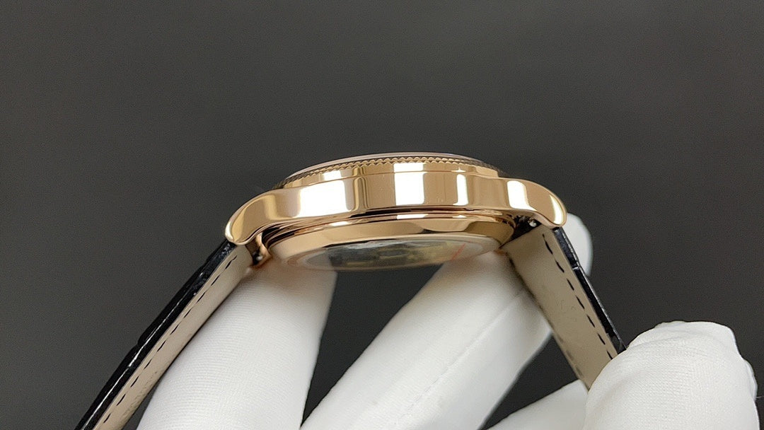 Patek Philippe wristwatch gold bezel and black leather strap, side angle