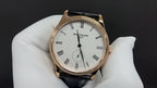 Patek Philippe wristwatch white dial with black leather strap and rose-gold bezel, front